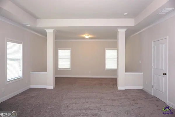an empty room with windows and closet