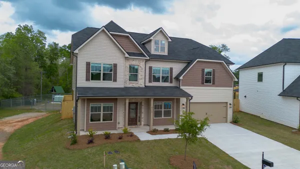 a front view of a house with a yard