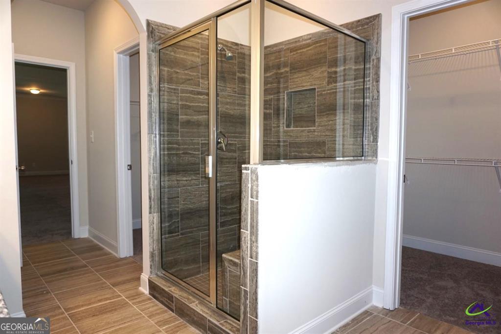 124 Bluecoat Trail Byron, GA 31008 - Photo 28 of 86 a bathroom with a glass shower door
