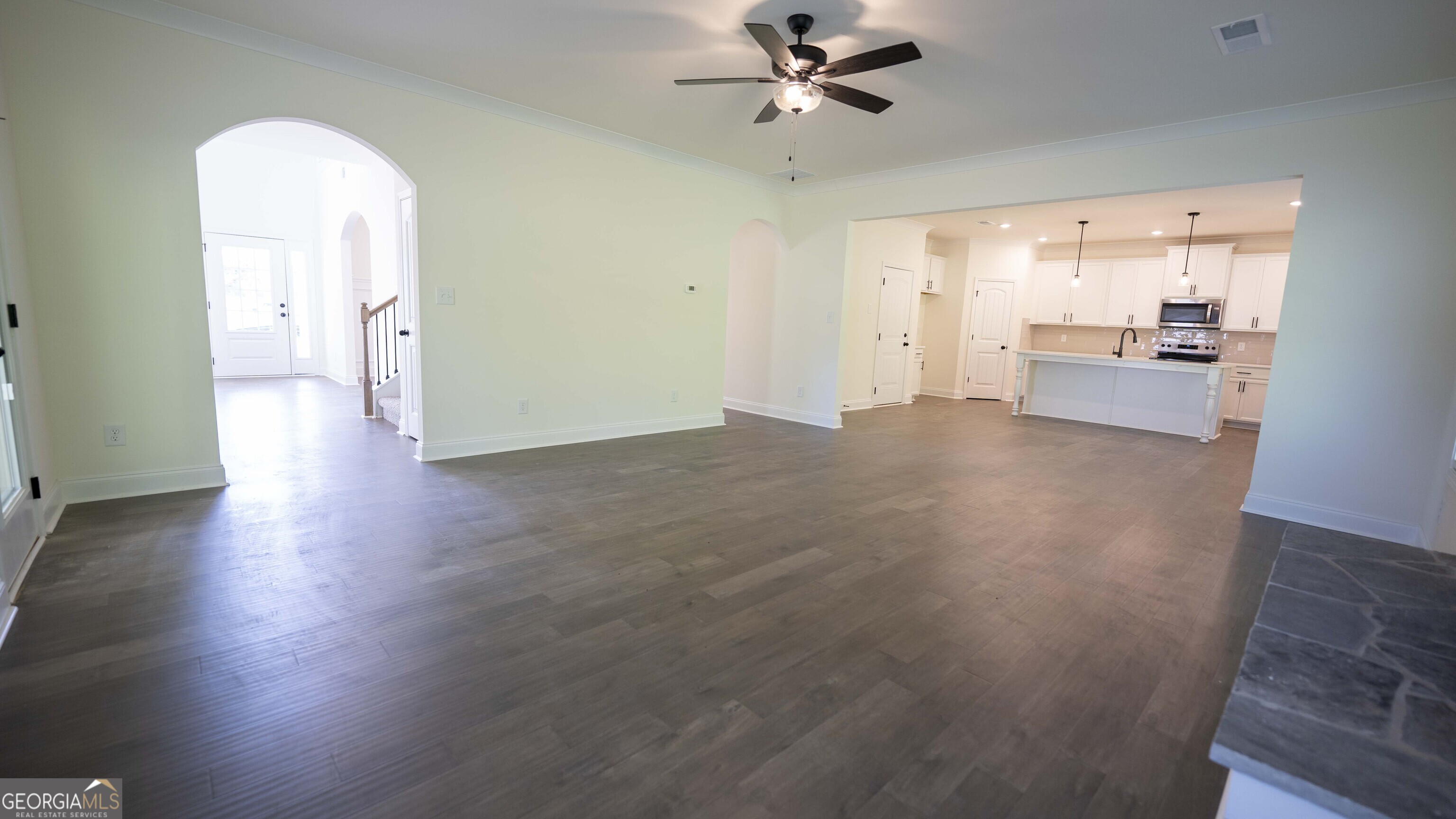 124 Bluecoat Trail Byron, GA 31008 - Photo 29 of 86 a view of a livingroom with wooden floor and a kitchen