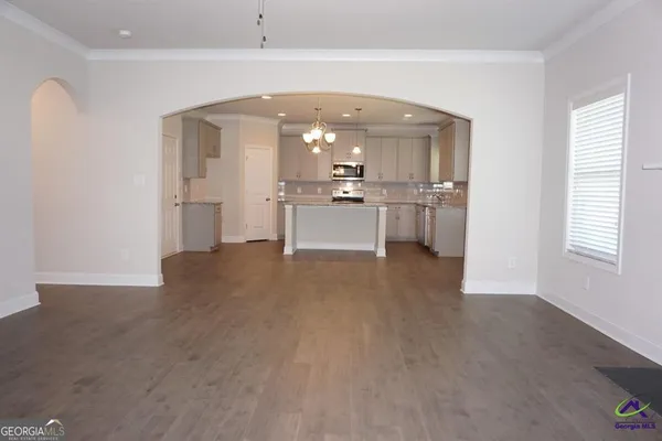 a view of a kitchen with a sink and a refrigerator