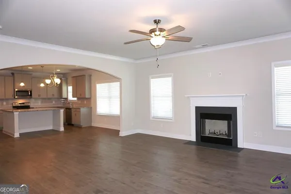 a view of an empty room with a fireplace and a window