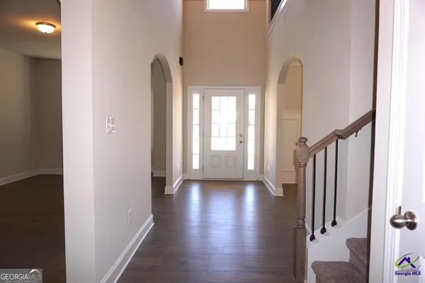 a view of an entryway with wooden floor