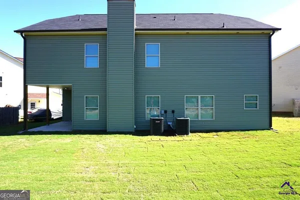 a view of house with yard