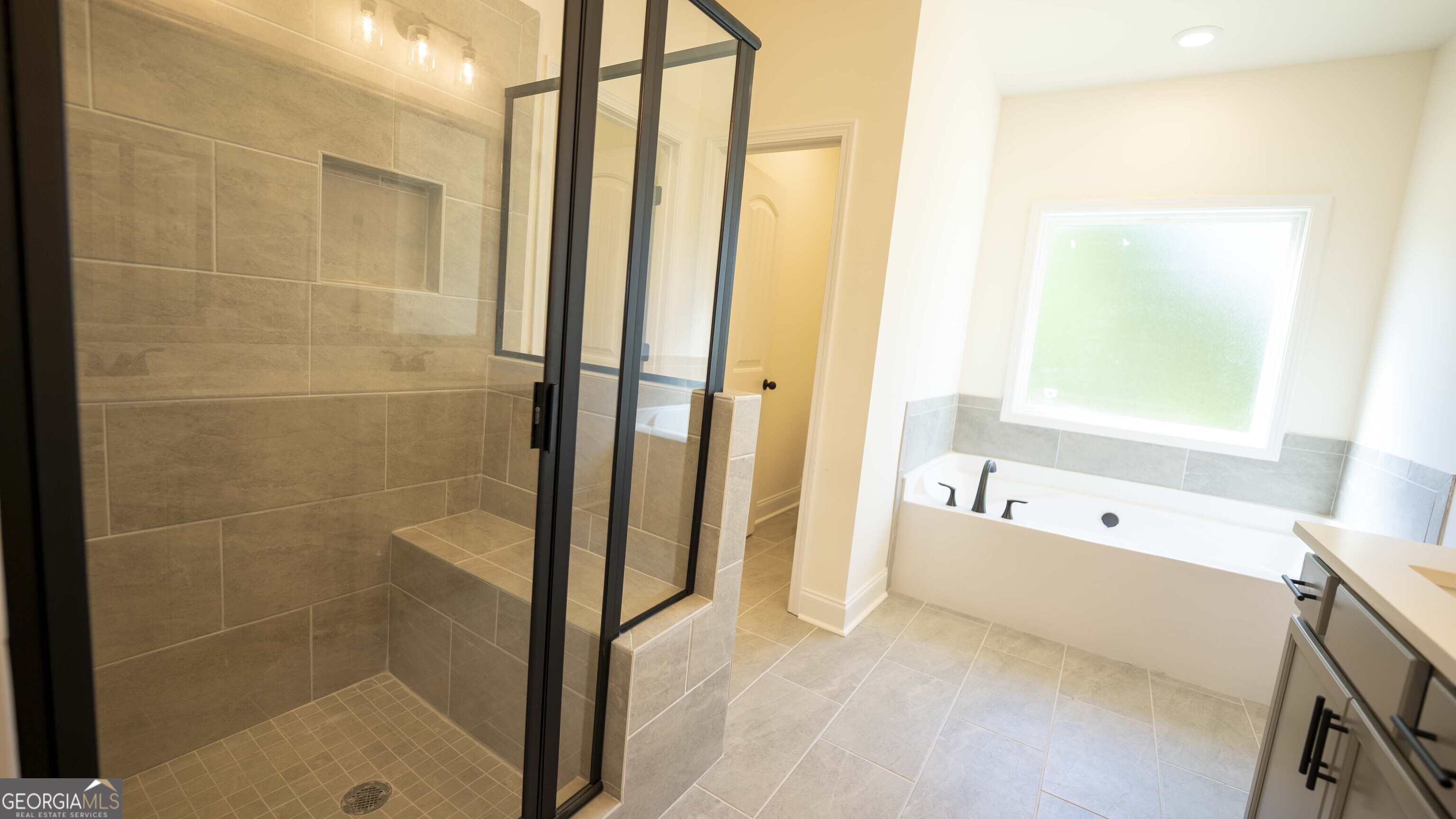124 Bluecoat Trail Byron, GA 31008 - Photo 55 of 86 a bathroom with a bathtub and a shower