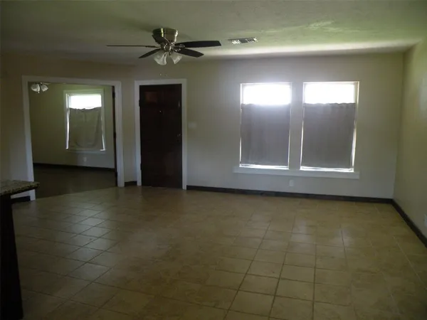 a view of a livingroom with a ceiling fan and window