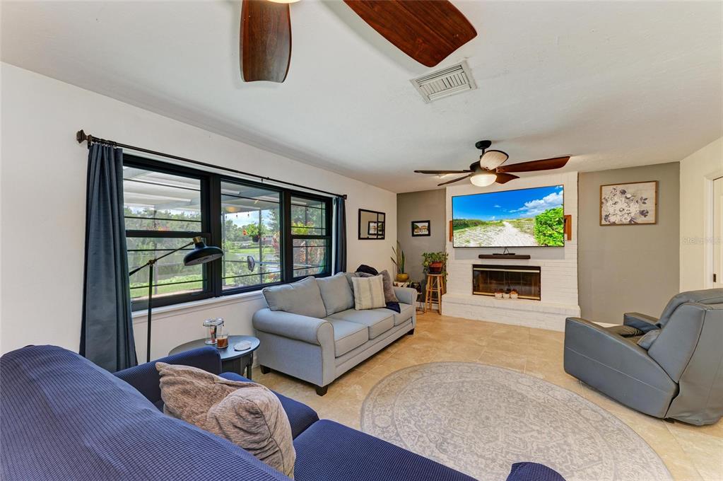 6114 Cypress Circle Bradenton, FL 34202 - Photo 11 of 67 a living room with furniture fireplace and flat screen tv