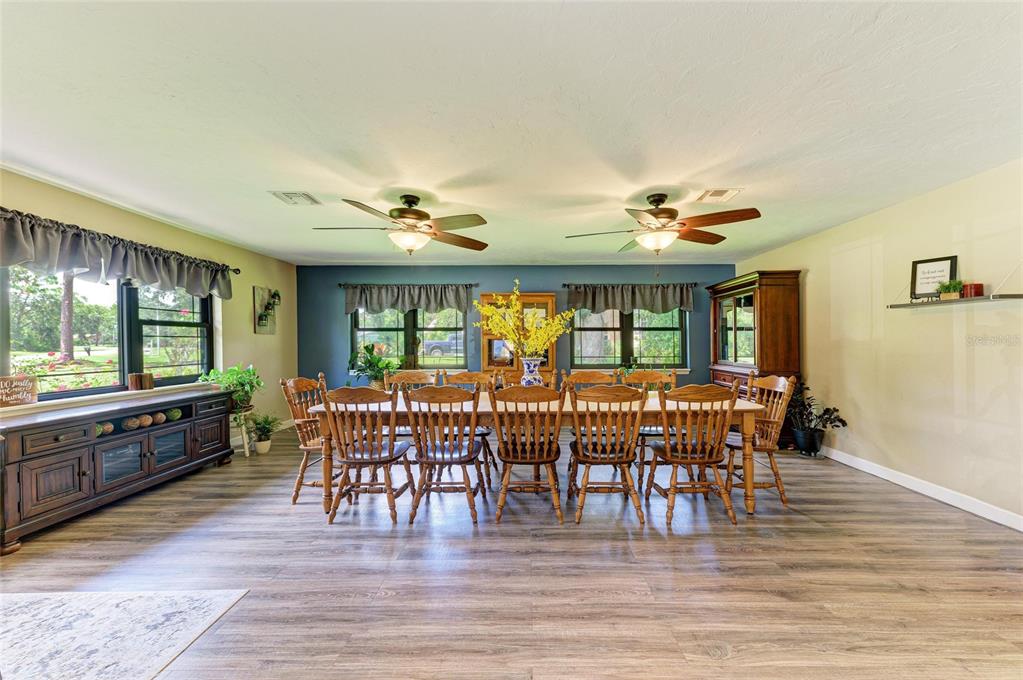 6114 Cypress Circle Bradenton, FL 34202 - Photo 13 of 67 a view of a dining room with furniture window and wooden floor