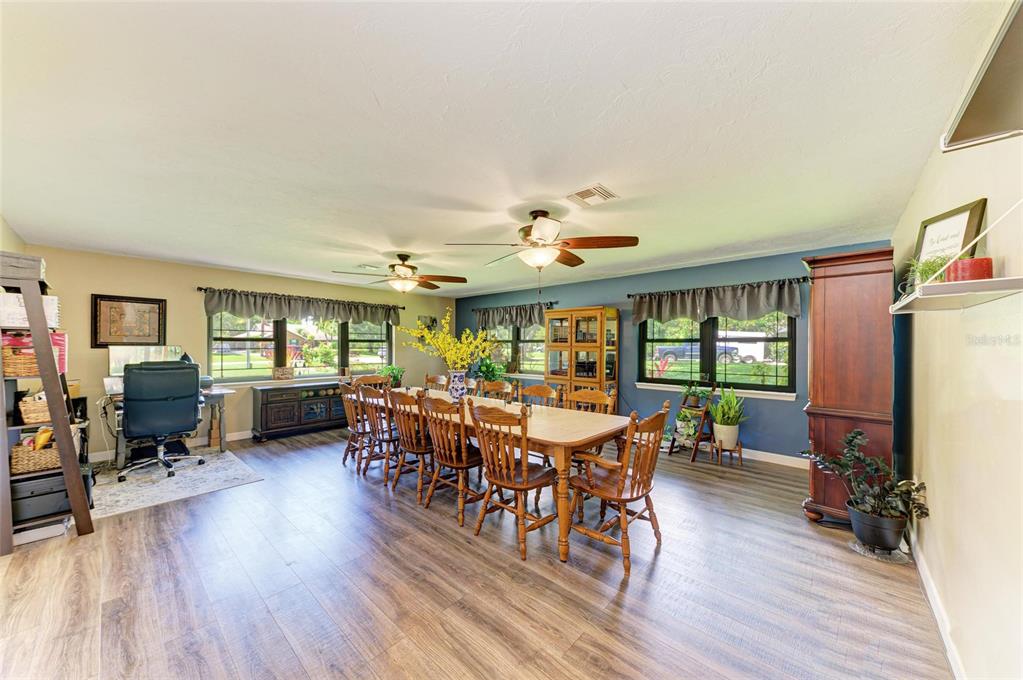 6114 Cypress Circle Bradenton, FL 34202 - Photo 14 of 67 a view of a dining room with furniture window and wooden floor