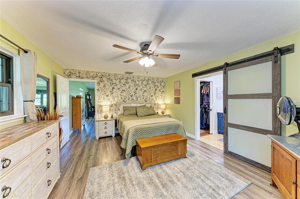 6114 Cypress Circle Bradenton, FL 34202 - Photo 16 of 67 a spacious bedroom with a bed and a walk in closet