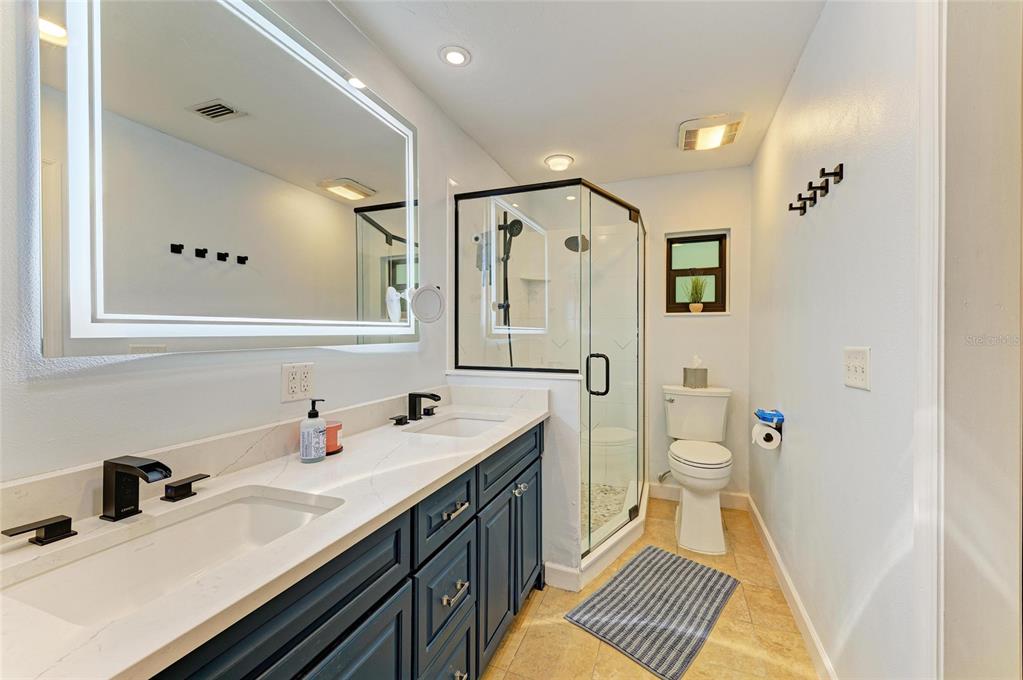 6114 Cypress Circle Bradenton, FL 34202 - Photo 18 of 67 a bathroom with a sink a toilet and a mirror