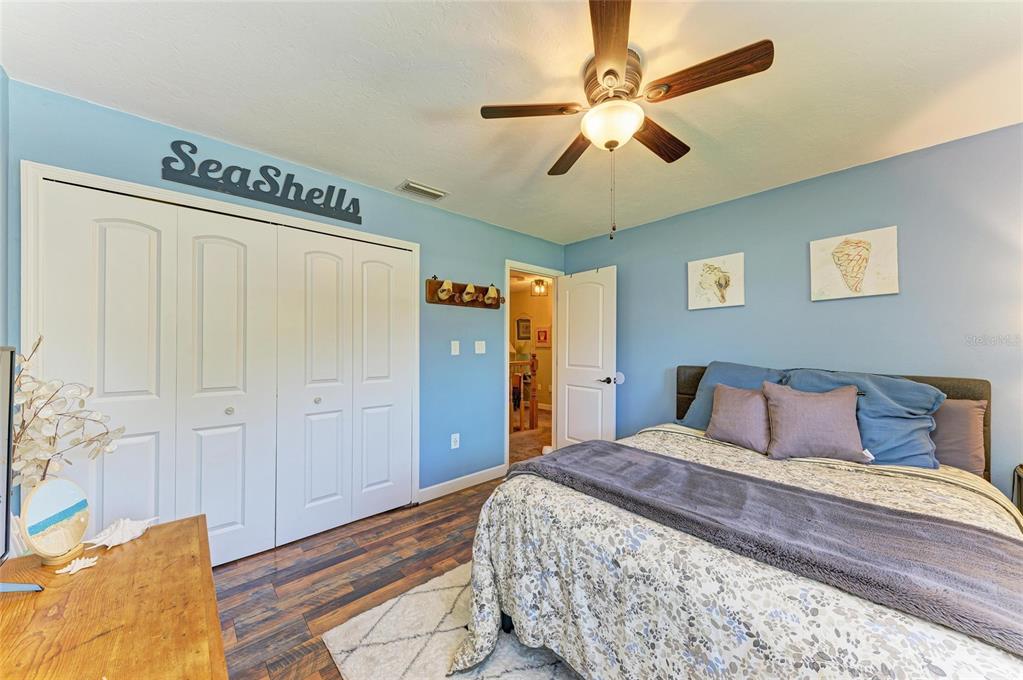 6114 Cypress Circle Bradenton, FL 34202 - Photo 20 of 67 a bedroom with a large bed and a chandelier