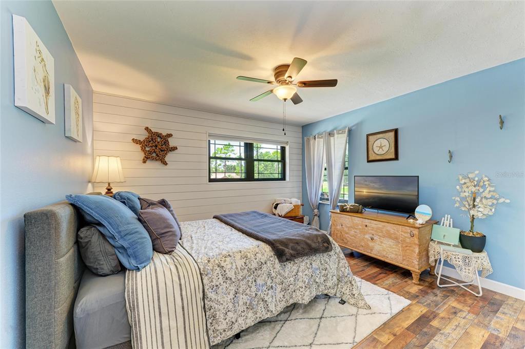 6114 Cypress Circle Bradenton, FL 34202 - Photo 21 of 67 a bedroom with a bed couch and window