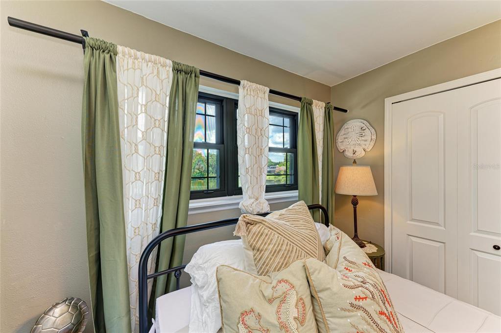 6114 Cypress Circle Bradenton, FL 34202 - Photo 23 of 67 a bedroom with a bed and glass window