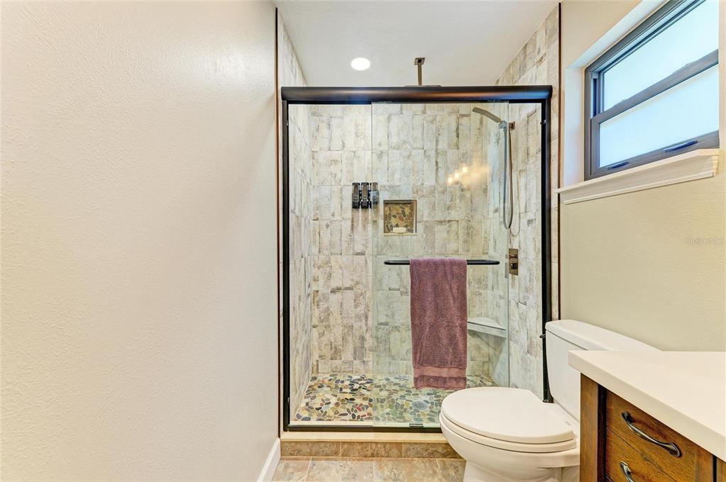 6114 Cypress Circle Bradenton, FL 34202 - Photo 25 of 67 a bathroom with a shower curtain and a toilet
