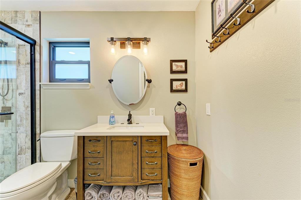 6114 Cypress Circle Bradenton, FL 34202 - Photo 26 of 67 a bathroom with a sink vanity mirror and toilet