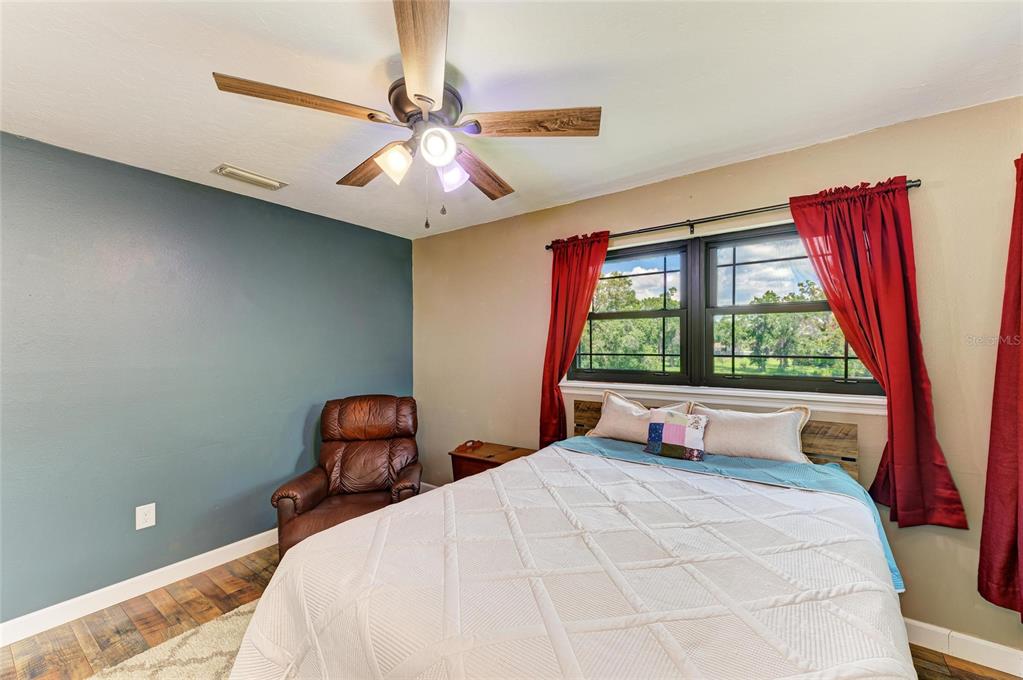 6114 Cypress Circle Bradenton, FL 34202 - Photo 28 of 67 a bedroom with a bed and a large window