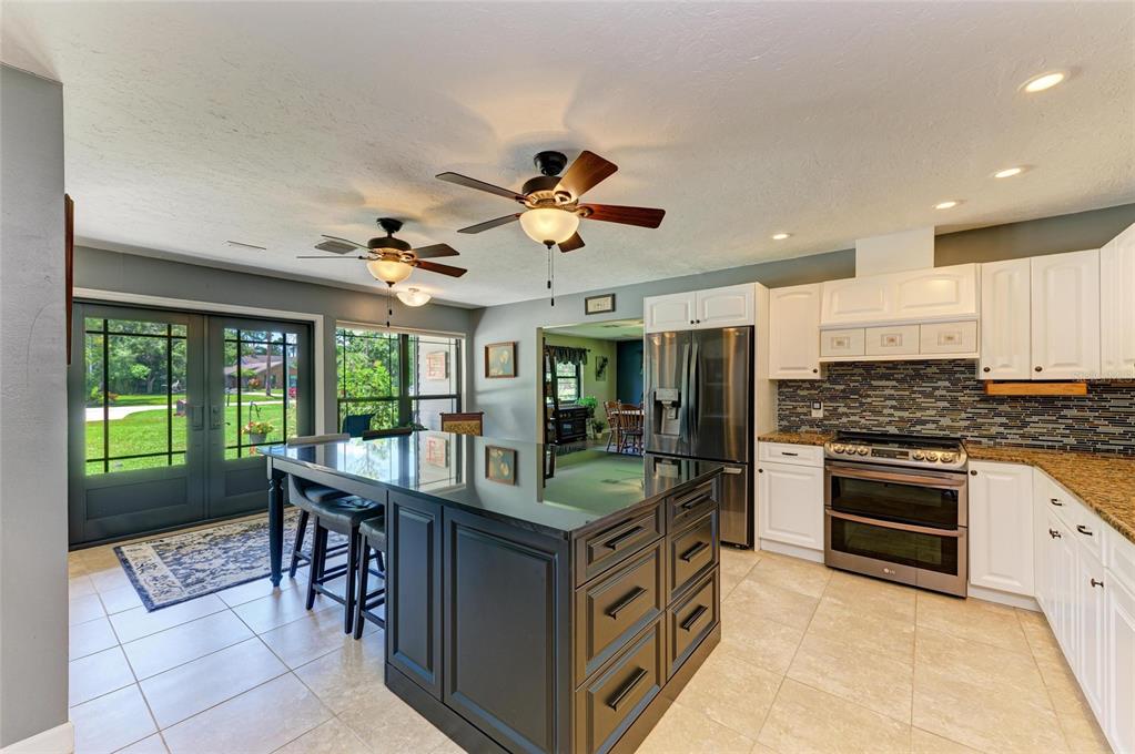 6114 Cypress Circle Bradenton, FL 34202 - Photo 3 of 67 a kitchen with stainless steel appliances granite countertop a stove and a sink