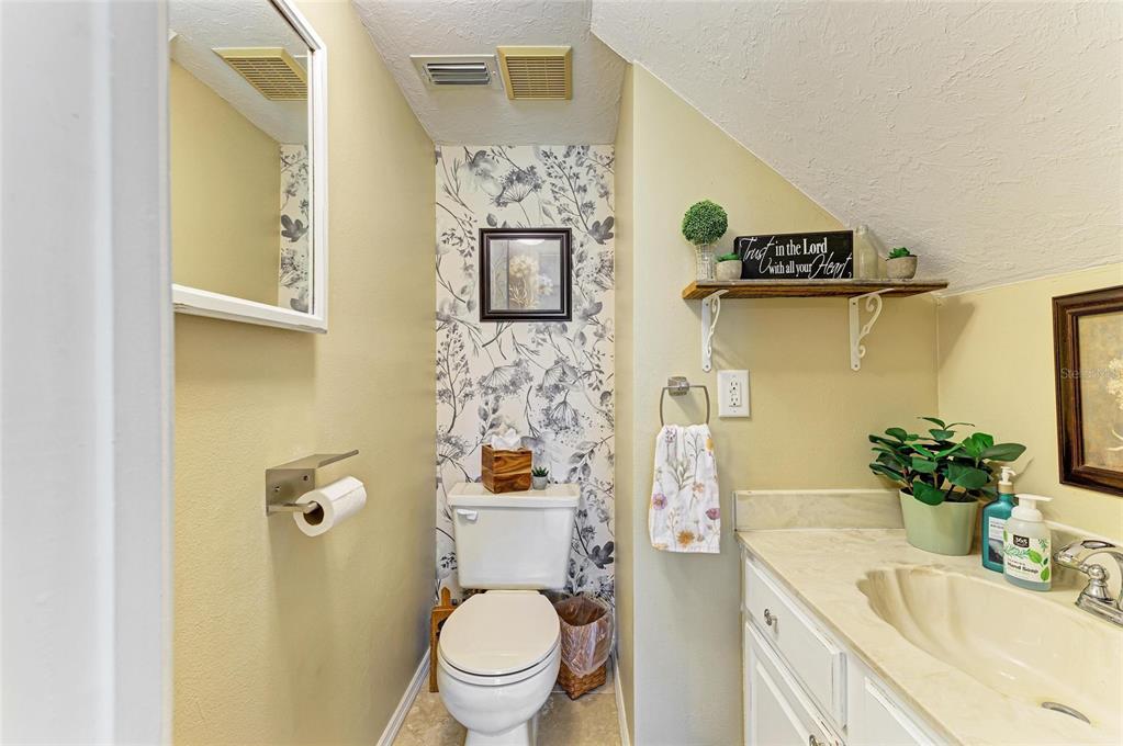 6114 Cypress Circle Bradenton, FL 34202 - Photo 31 of 67 a bathroom with a sink mirror vanity and toilet