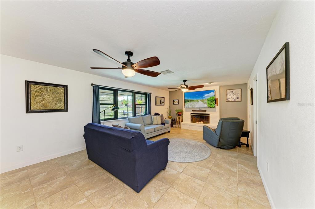 6114 Cypress Circle Bradenton, FL 34202 - Photo 46 of 67 a living room with furniture a ceiling fan and a window