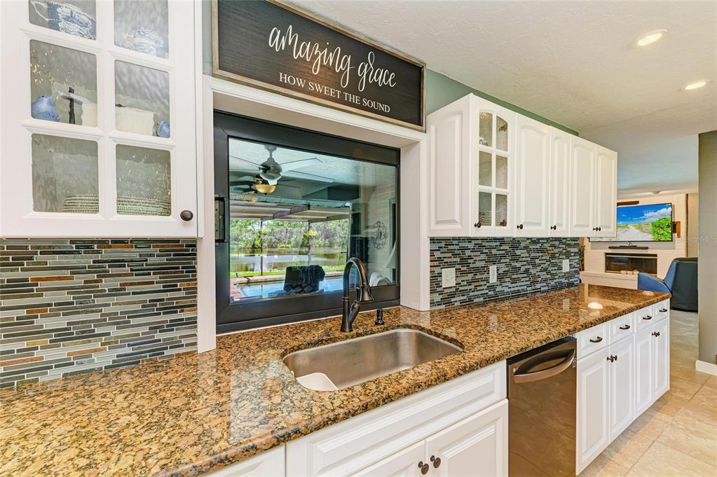 6114 Cypress Circle Bradenton, FL 34202 - Photo 8 of 67 a kitchen with granite countertop a sink and a stove