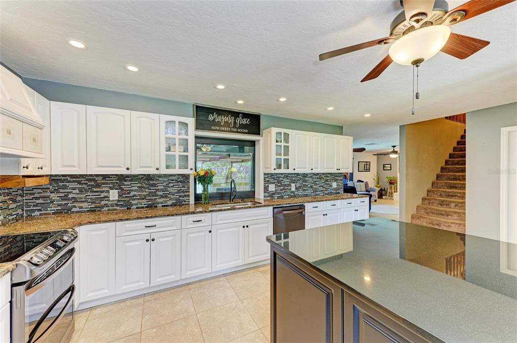 6114 Cypress Circle Bradenton, FL 34202 - Photo 10 of 67 a kitchen with a sink a counter top space cabinets and stainless steel appliances