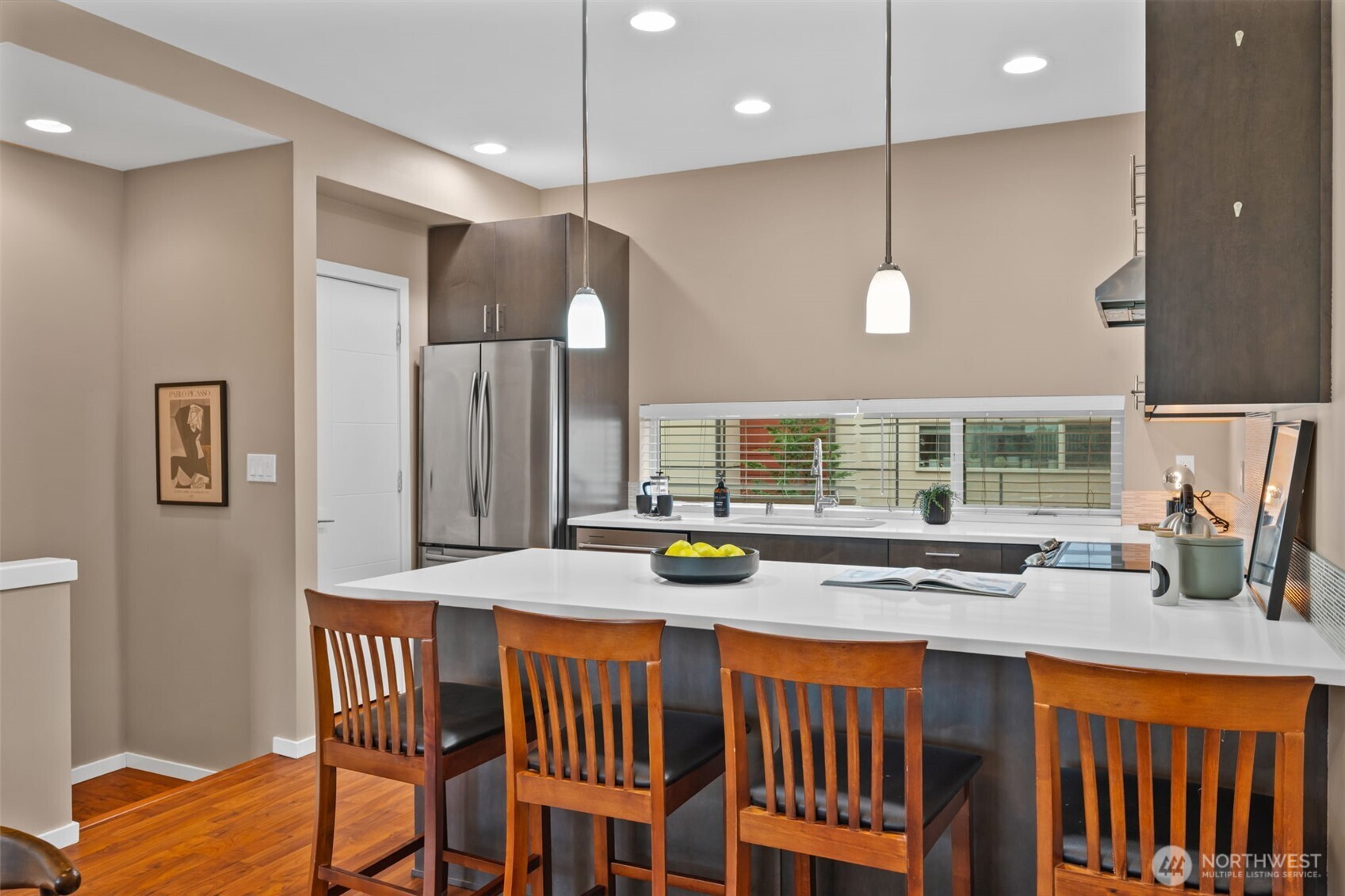 2311 North 113th Place, Unit B Seattle, WA 98133 - Photo 14 of 36 a kitchen with a table chairs stove and wooden floor
