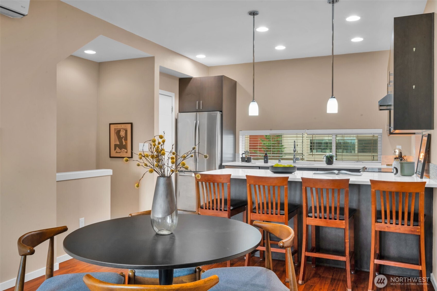 2311 North 113th Place, Unit B Seattle, WA 98133 - Photo 15 of 36 a kitchen with a table chairs stove and refrigerator