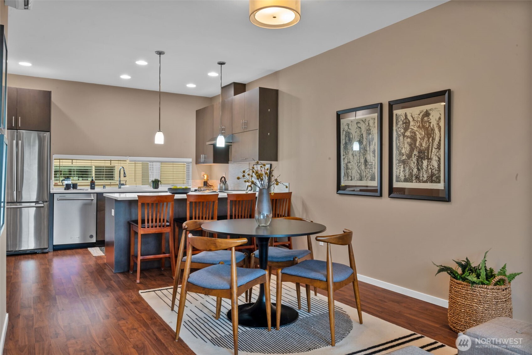 2311 North 113th Place, Unit B Seattle, WA 98133 - Photo 18 of 36 a kitchen with a dining table chairs and refrigerator