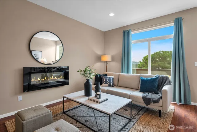 a living room with furniture a fireplace and a potted plant