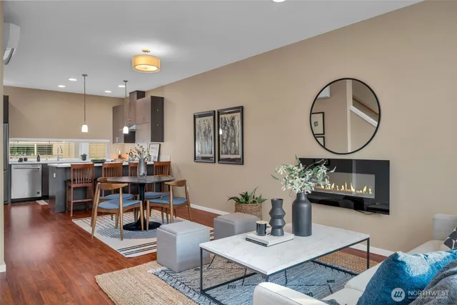 a living room with furniture a table and kitchen view