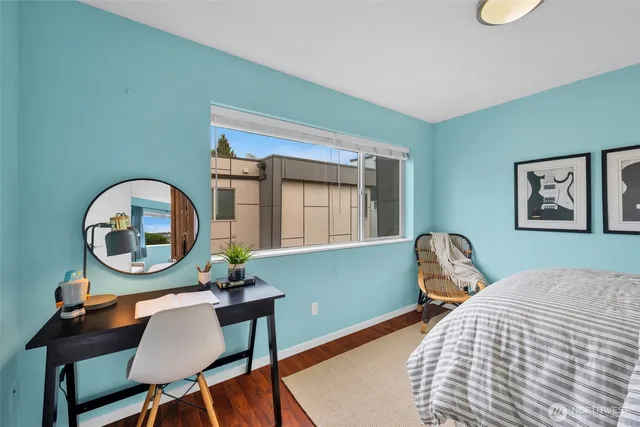a bedroom with a bed and a painting on the wall