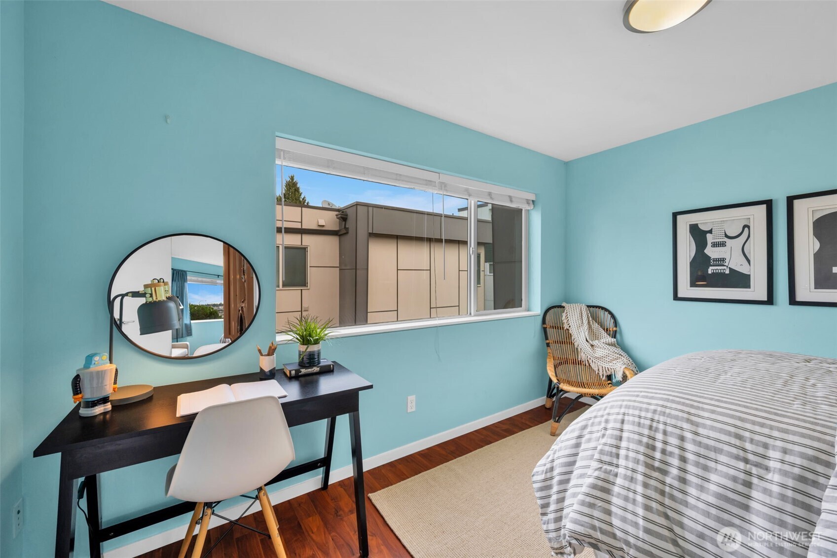 2311 North 113th Place, Unit B Seattle, WA 98133 - Photo 29 of 36 a bedroom with a bed a mirror and a table