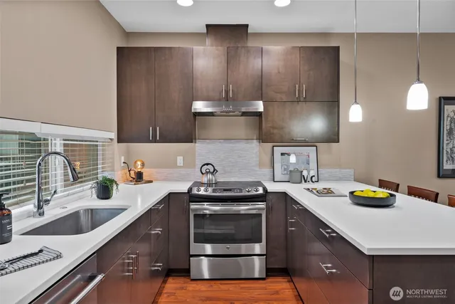 a kitchen with a sink stove and cabinets