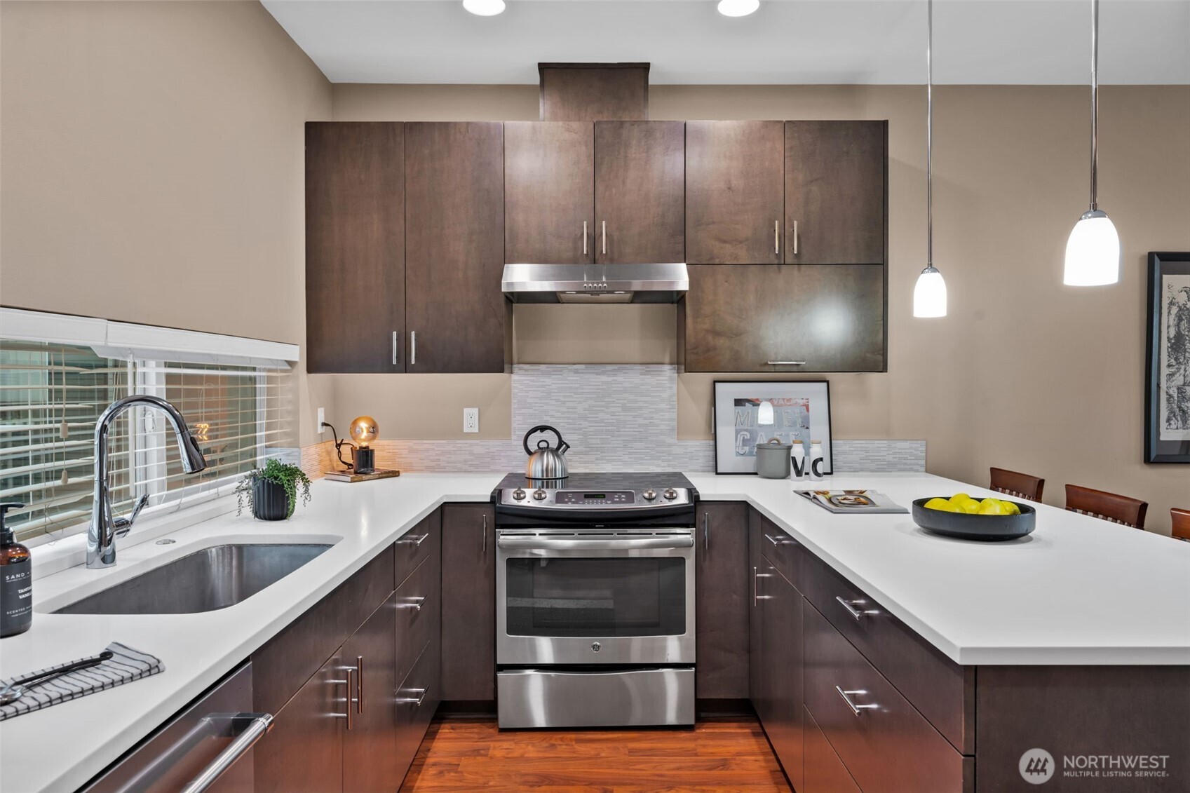 2311 North 113th Place, Unit B Seattle, WA 98133 - Photo 8 of 36 a kitchen with a sink stove and cabinets