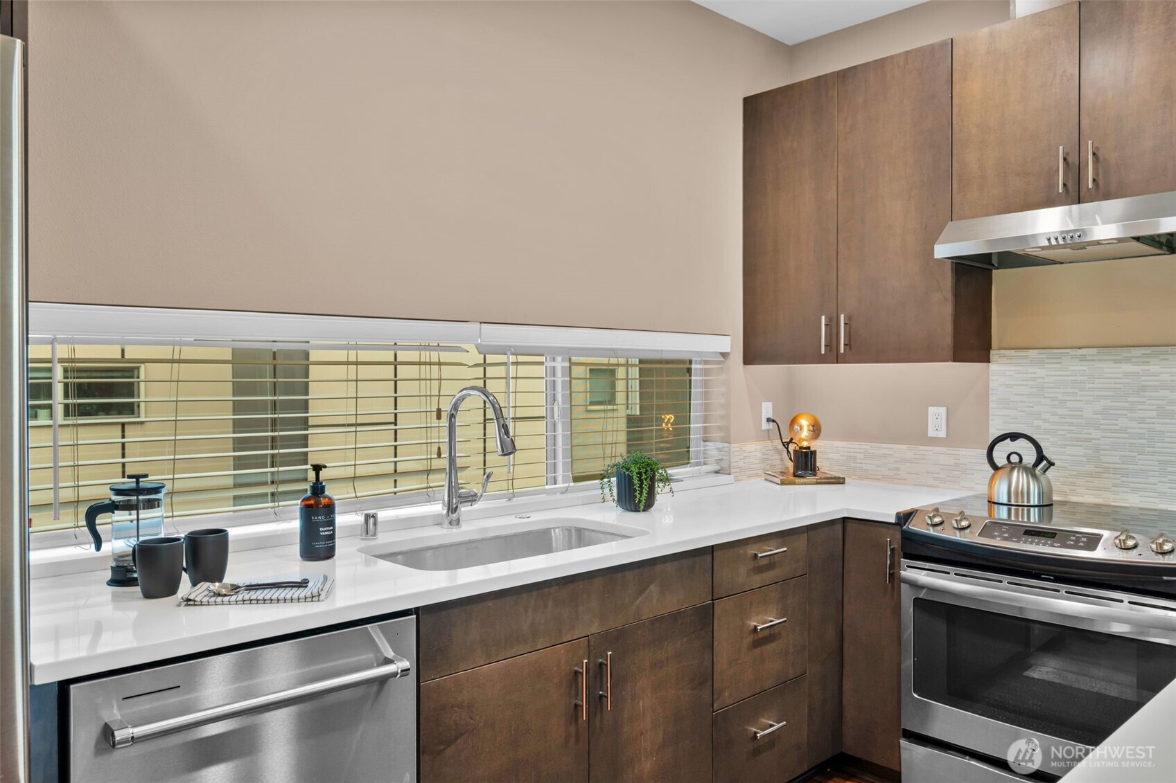 2311 North 113th Place, Unit B Seattle, WA 98133 - Photo 9 of 36 a kitchen with stainless steel appliances a sink stove and cabinets