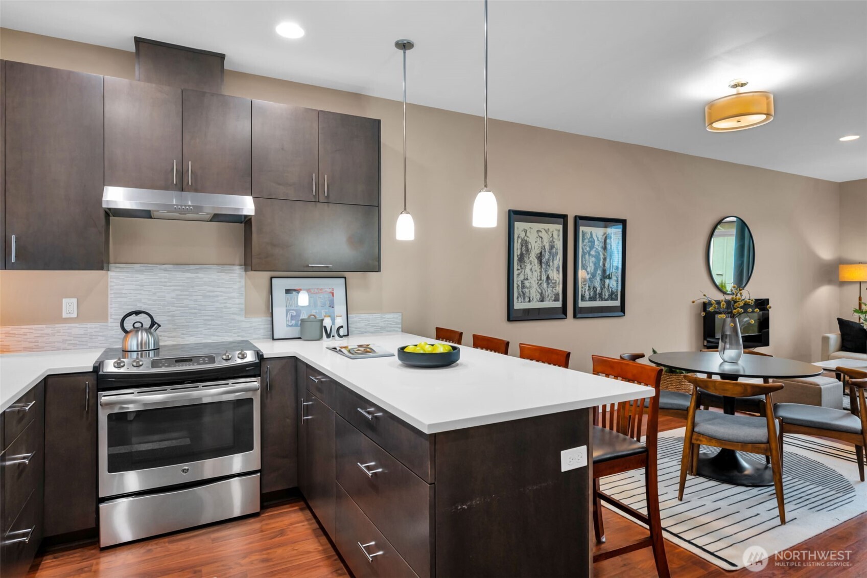 2311 North 113th Place, Unit B Seattle, WA 98133 - Photo 10 of 36 a kitchen with a stove a sink a dining table and chairs