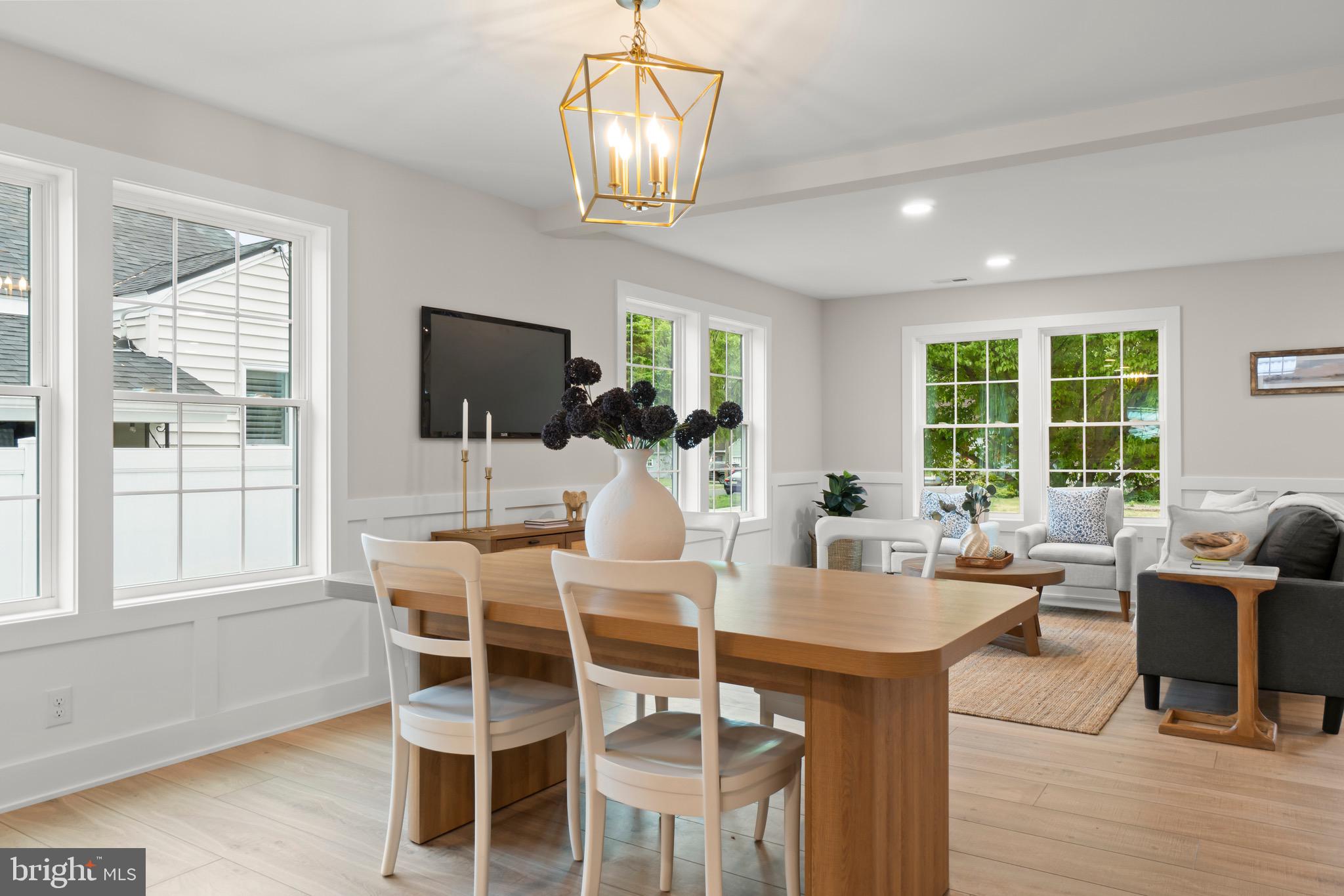 1505 Chestnut Avenue Haddon Heights, NJ 08035 - Photo 11 of 38 a dining room with wooden floor a chandelier a glass table and chairs