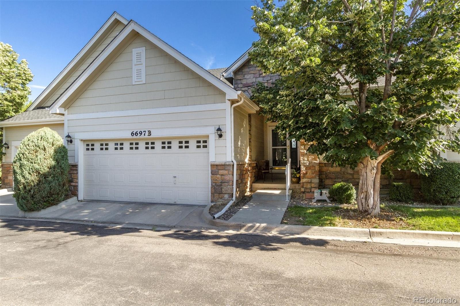 a view of a house with a yard and garage