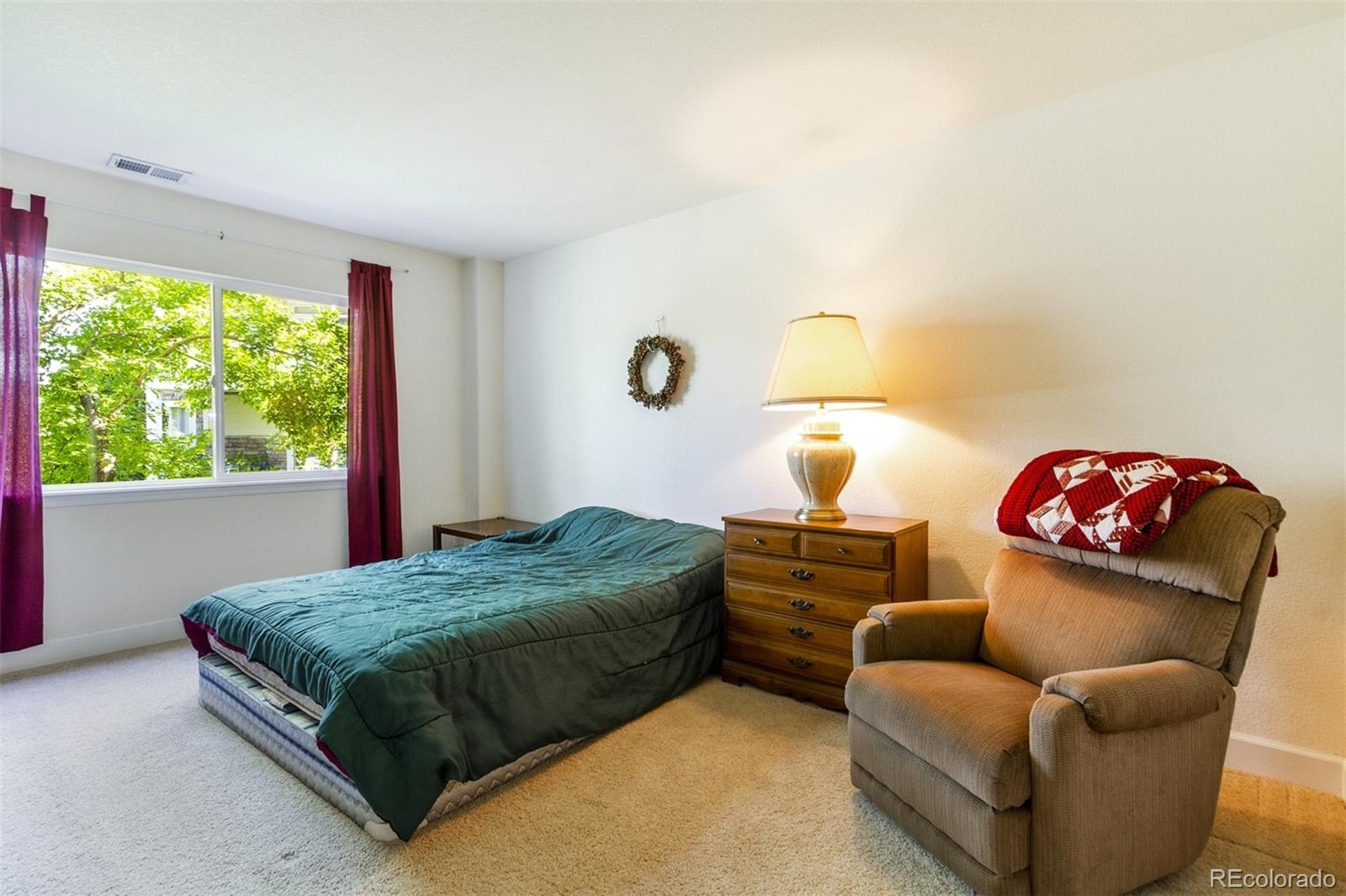 6697 South Reed Way, Unit B Littleton, CO 80123 - Photo 18 of 35 a bedroom with a bed and window