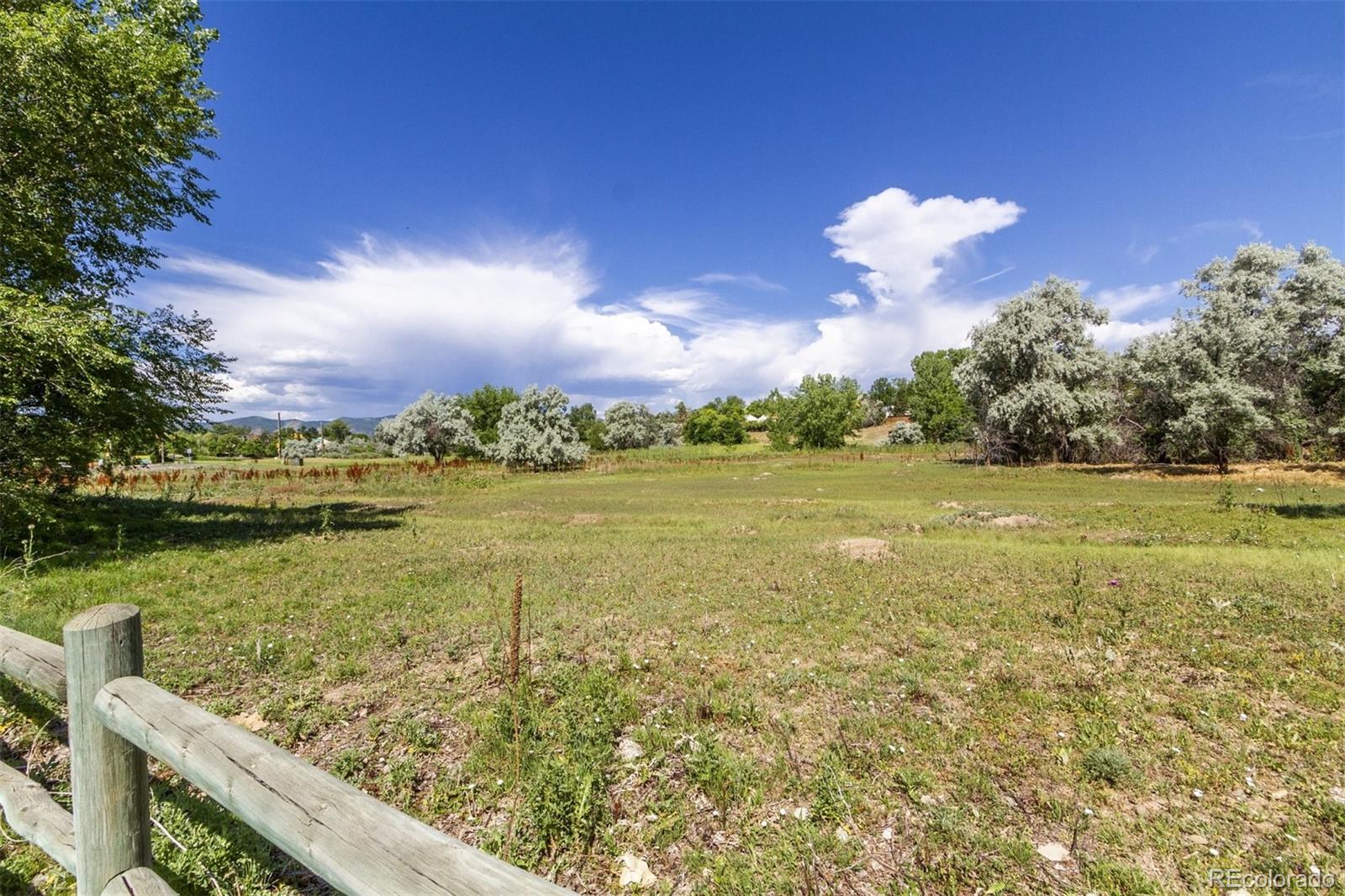6697 South Reed Way, Unit B Littleton, CO 80123 - Photo 27 of 35 a view of a lake with a big yard
