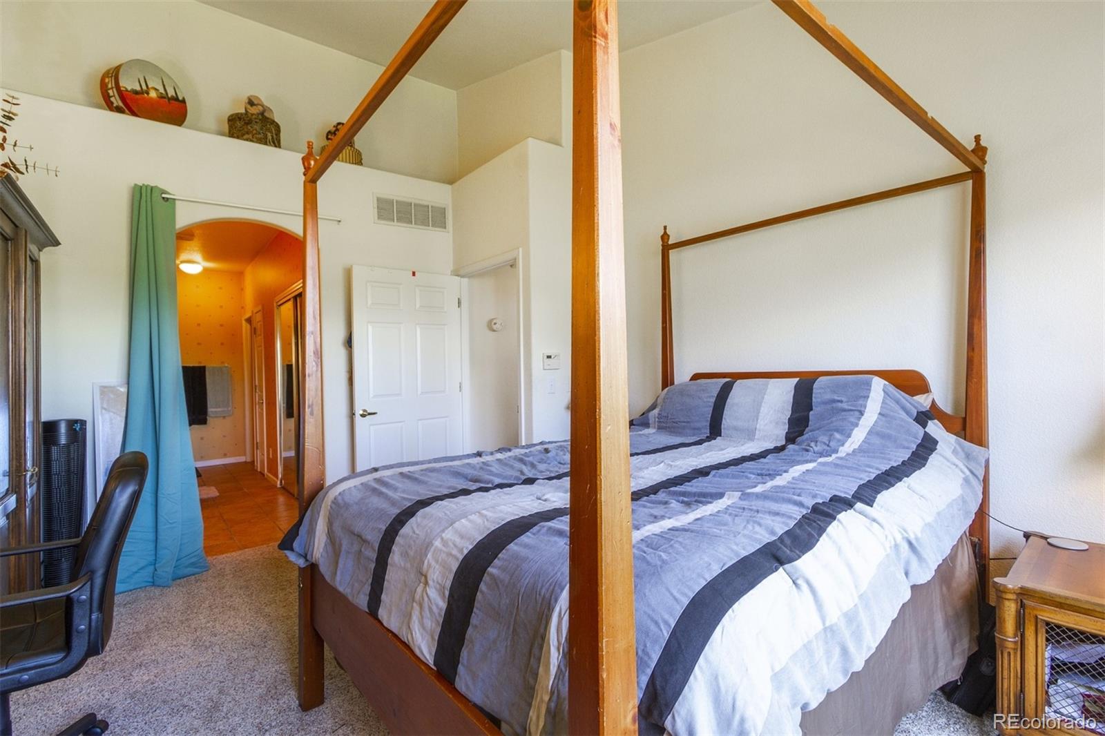 6697 South Reed Way, Unit B Littleton, CO 80123 - Photo 29 of 35 a bed sitting in a bedroom next to a window