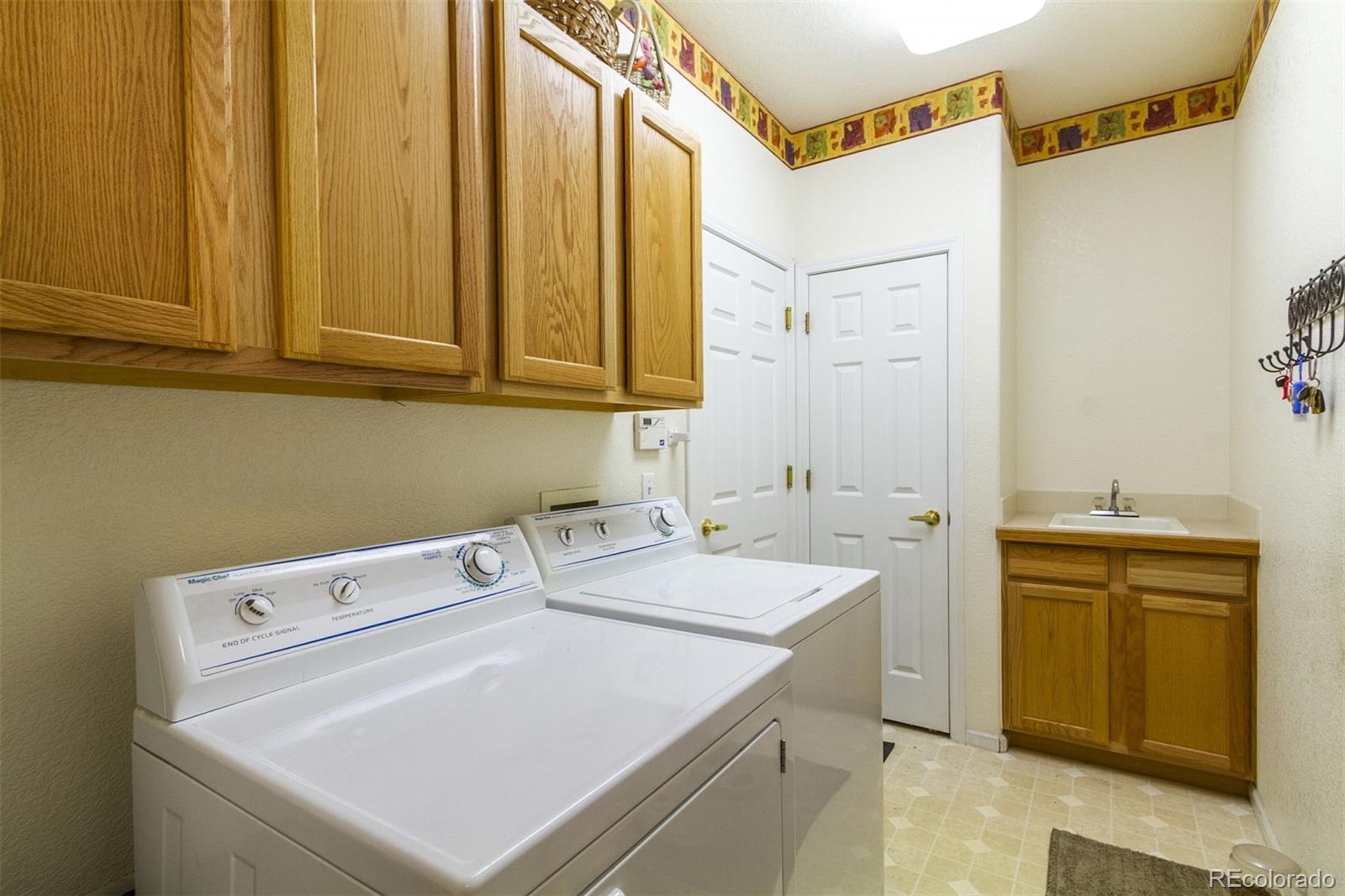 6697 South Reed Way, Unit B Littleton, CO 80123 - Photo 34 of 35 a utility room with dryer and washer