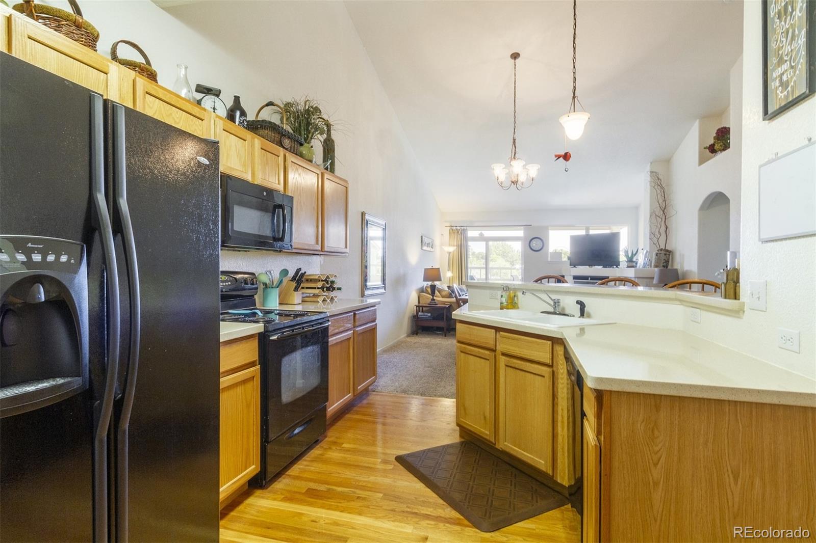 6697 South Reed Way, Unit B Littleton, CO 80123 - Photo 5 of 35 a kitchen with stainless steel appliances granite countertop a sink a stove and a refrigerator