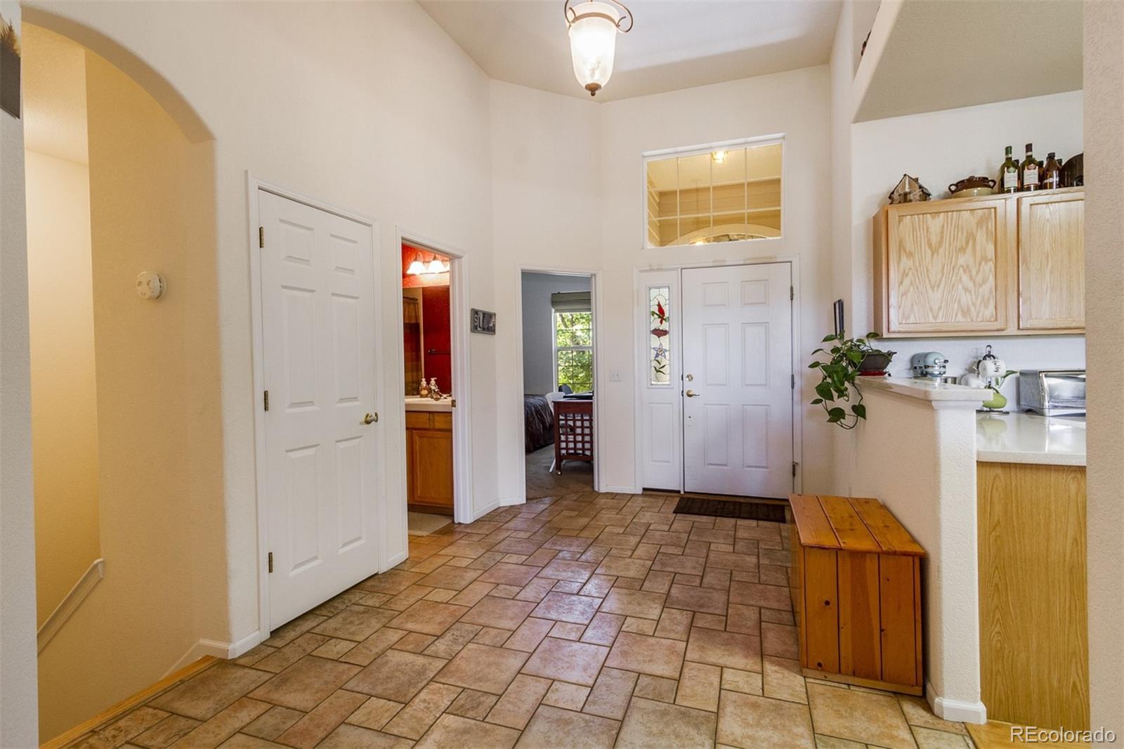 6697 South Reed Way, Unit B Littleton, CO 80123 - Photo 7 of 35 a view of a hallway view with wooden floor and staircase