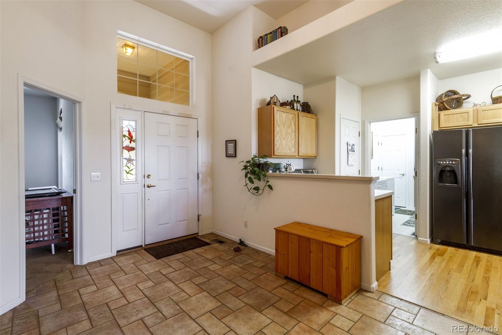 6697 South Reed Way, Unit B Littleton, CO 80123 - Photo 8 of 35 a kitchen with stainless steel appliances granite countertop a refrigerator and a stove top oven