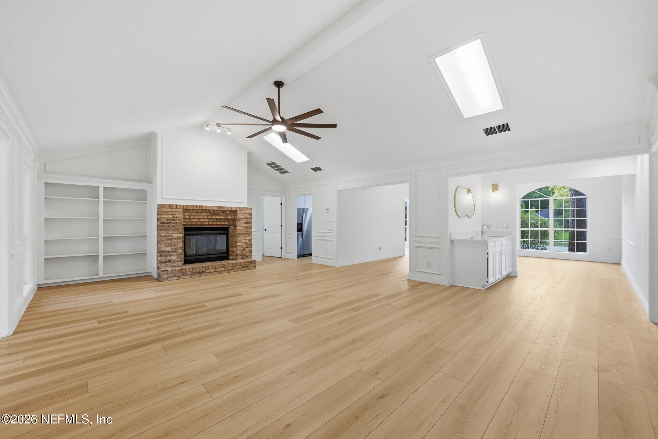 3286 Marbon Road Jacksonville, FL 32223 - Photo 9 of 36 an empty room with fireplace cabinet and windows