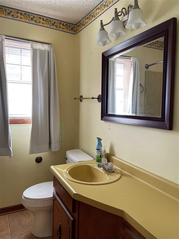 3990 Ebenezer Road Toone, TN 38381 - Photo 10 of 21 a bathroom with a sink a toilet and mirror