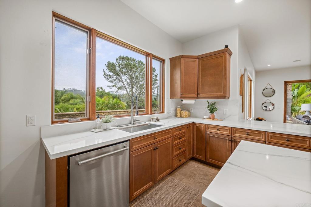 4149 Manchester Avenue Encinitas, CA 92024 - Photo 17 of 60 a kitchen with a sink window and cabinets