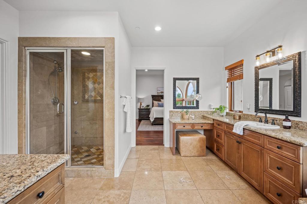 4149 Manchester Avenue Encinitas, CA 92024 - Photo 32 of 60 a large bathroom with a granite countertop double vanity sink a mirror and a bathtub